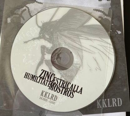 Zinc / Estricalla / Humilitate / Mostros ‎– KKLRD - 7" - Blanco / White - 2012 - Bonberenea Ekintzak ‎– BONB 036 - Nuevo sin usar pero no precintado / New and unplayed but not sealed.